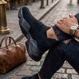 Black lace-up sneakers with knit upper and chunky rubber outsole