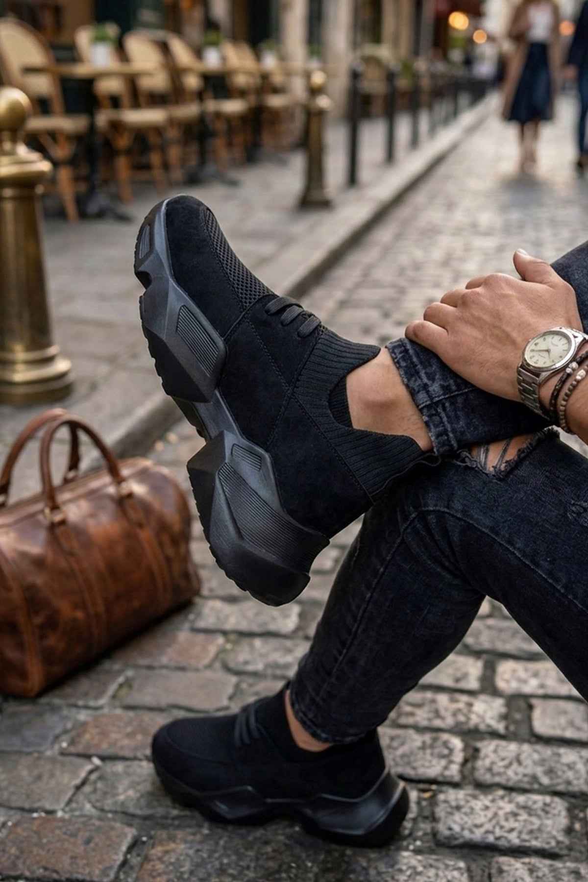 Black lace-up sneakers with knit upper and chunky rubber outsole
