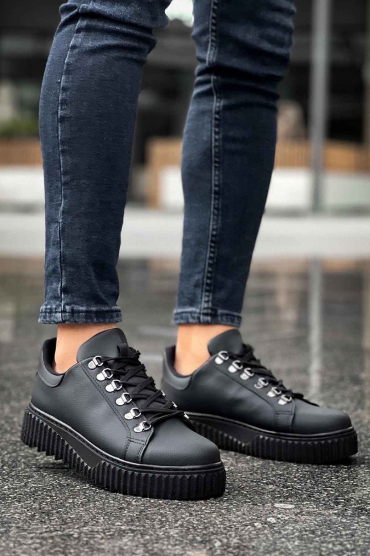 Men's black lace-up sneakers with chunky tread platform sole, side view