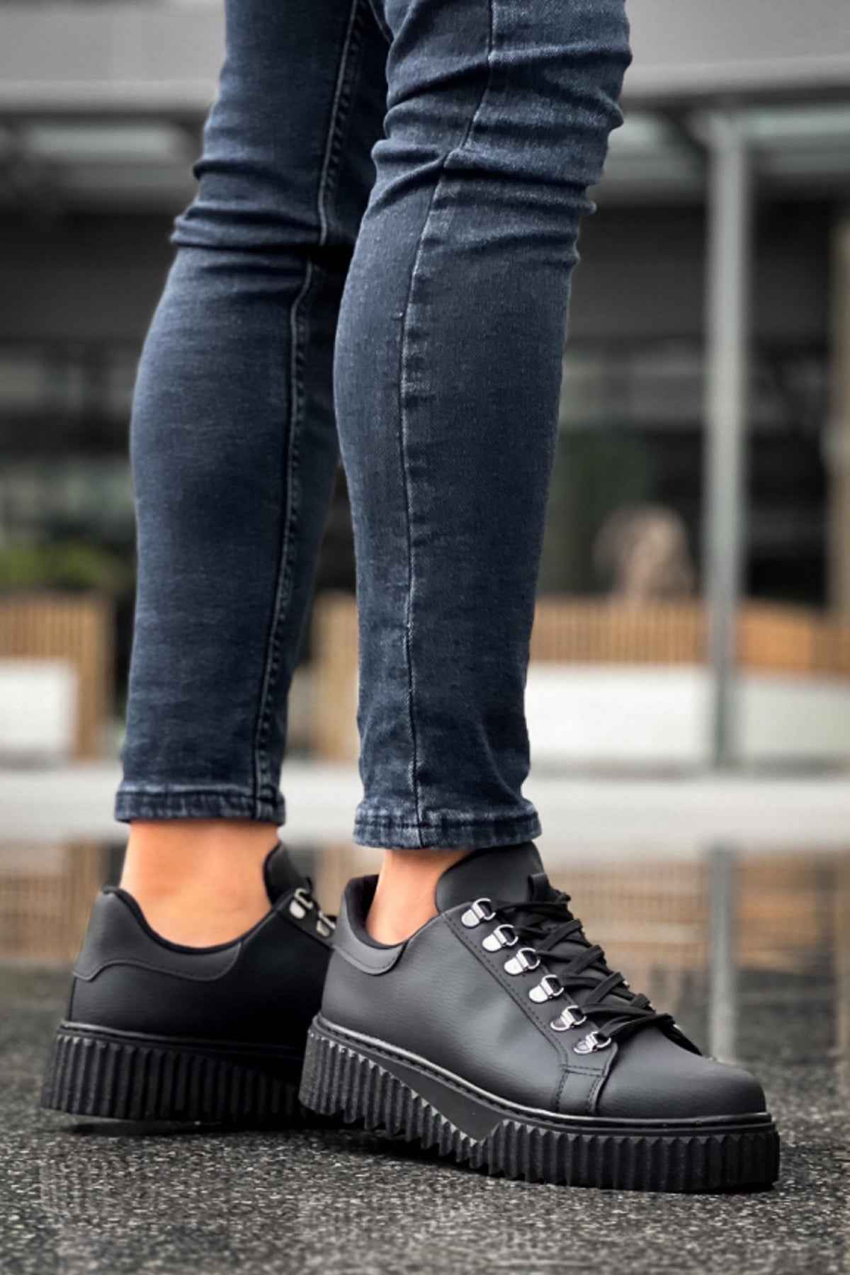 Men's black sneakers with thick ridged platform sole and lace-up design