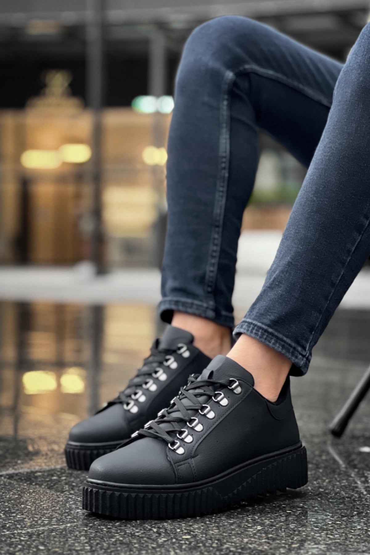 Men's black lace-up sneakers on chunky platform sole, side view