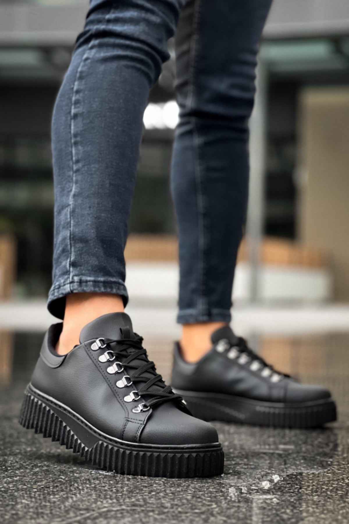 Men's black lace-up sneakers with platform sole, front three-quarter view