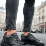 Men's black sneakers, lace-up with low profile rubber sole.