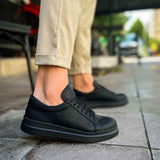 Black lace-up sneakers with textured finish and side stitching detail