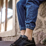 Men's black lace-up sneakers with rounded toe and rubber sole