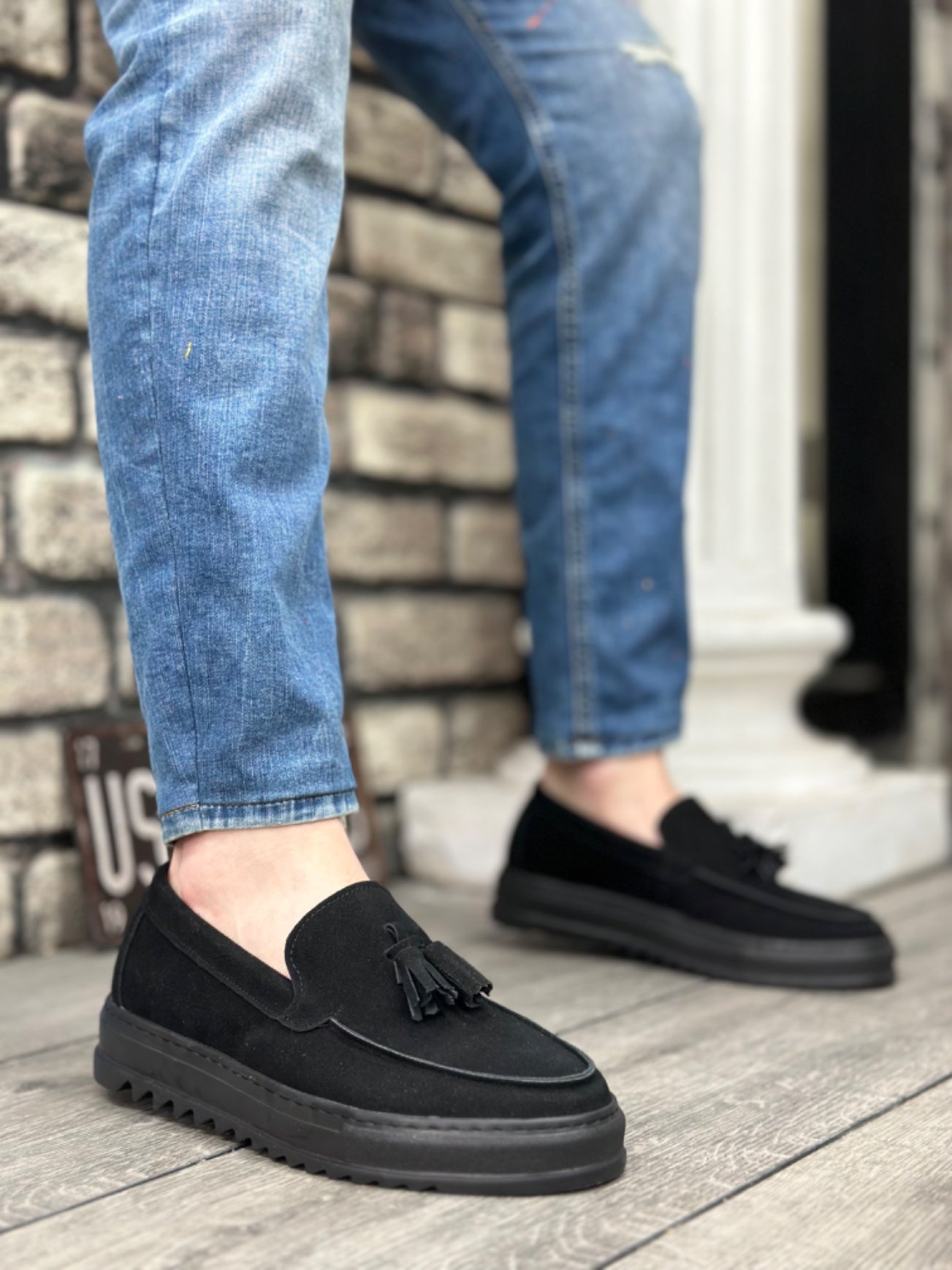 Men's black suede loafers with tassel detail and cushioned thick sole