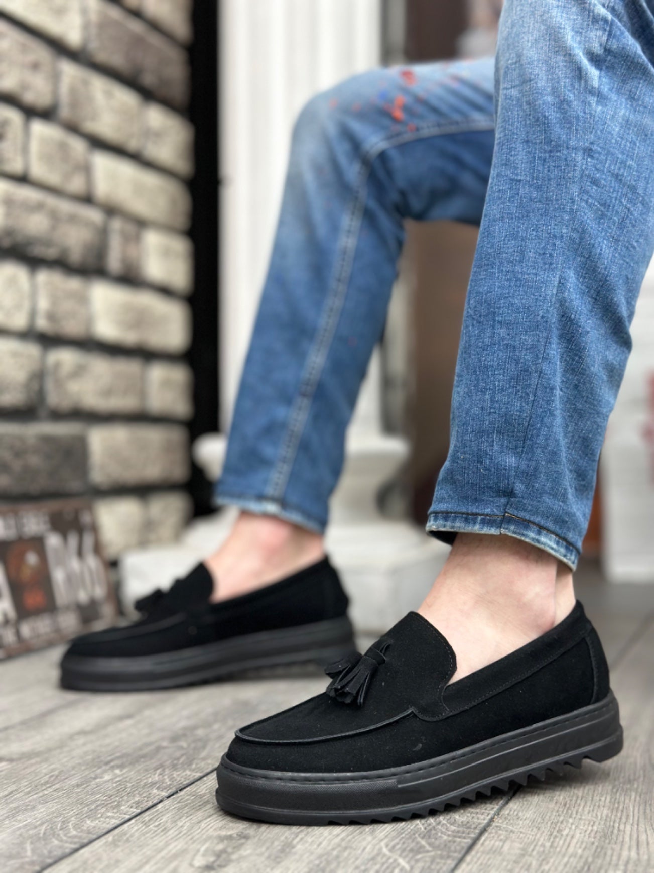 Men's black suede loafer, side view, tassel accent and grippy tread sole