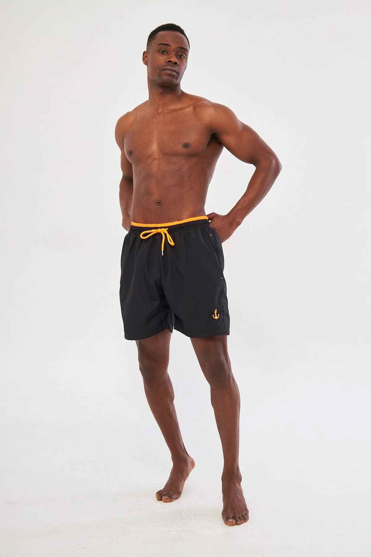 Men's black swim shorts with orange drawstring and small side logo detail.
