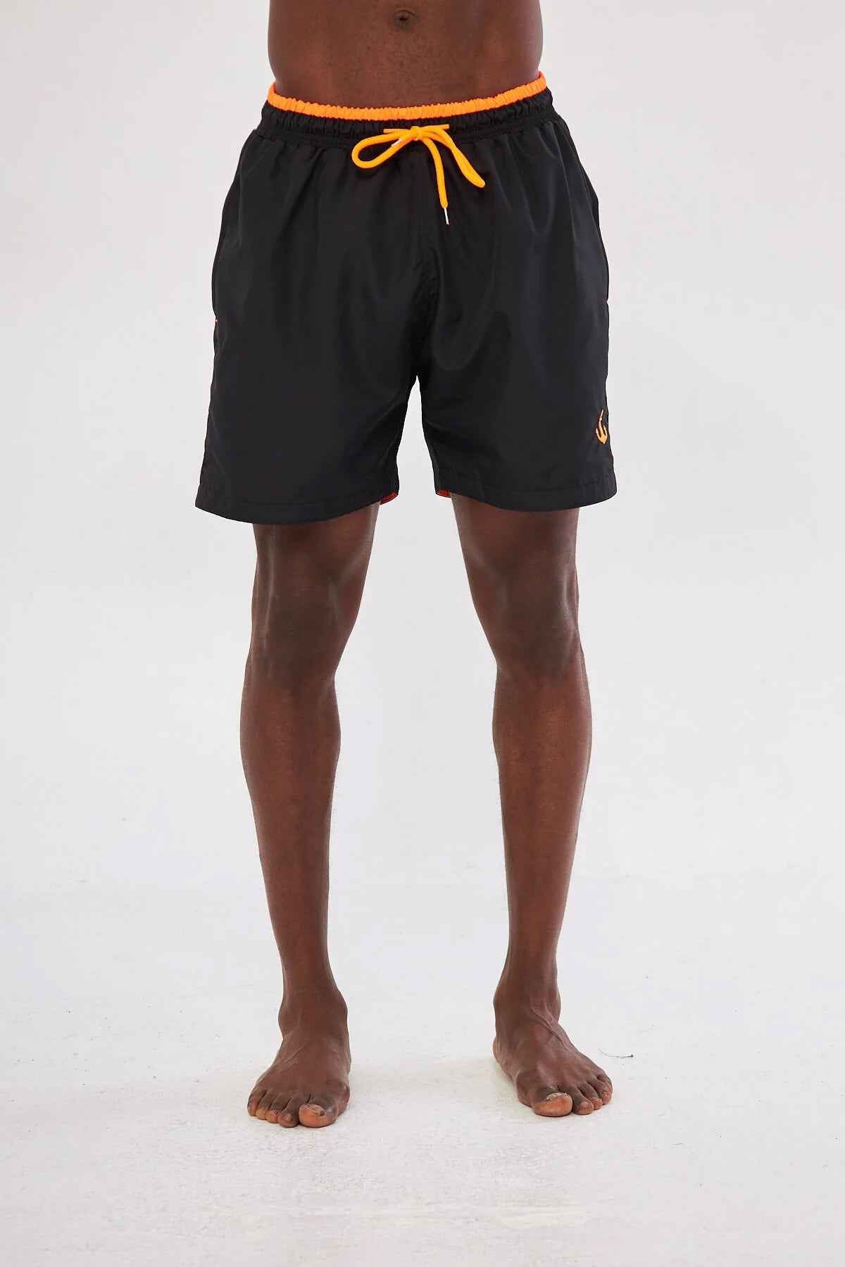 Men's black swim shorts with orange elastic waistband trim and drawstring ties.