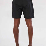 Men's black swim shorts back view with orange waistband trim and elastic hem.