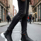 Men's black ankle boots with white chunky soles and elastic side panels