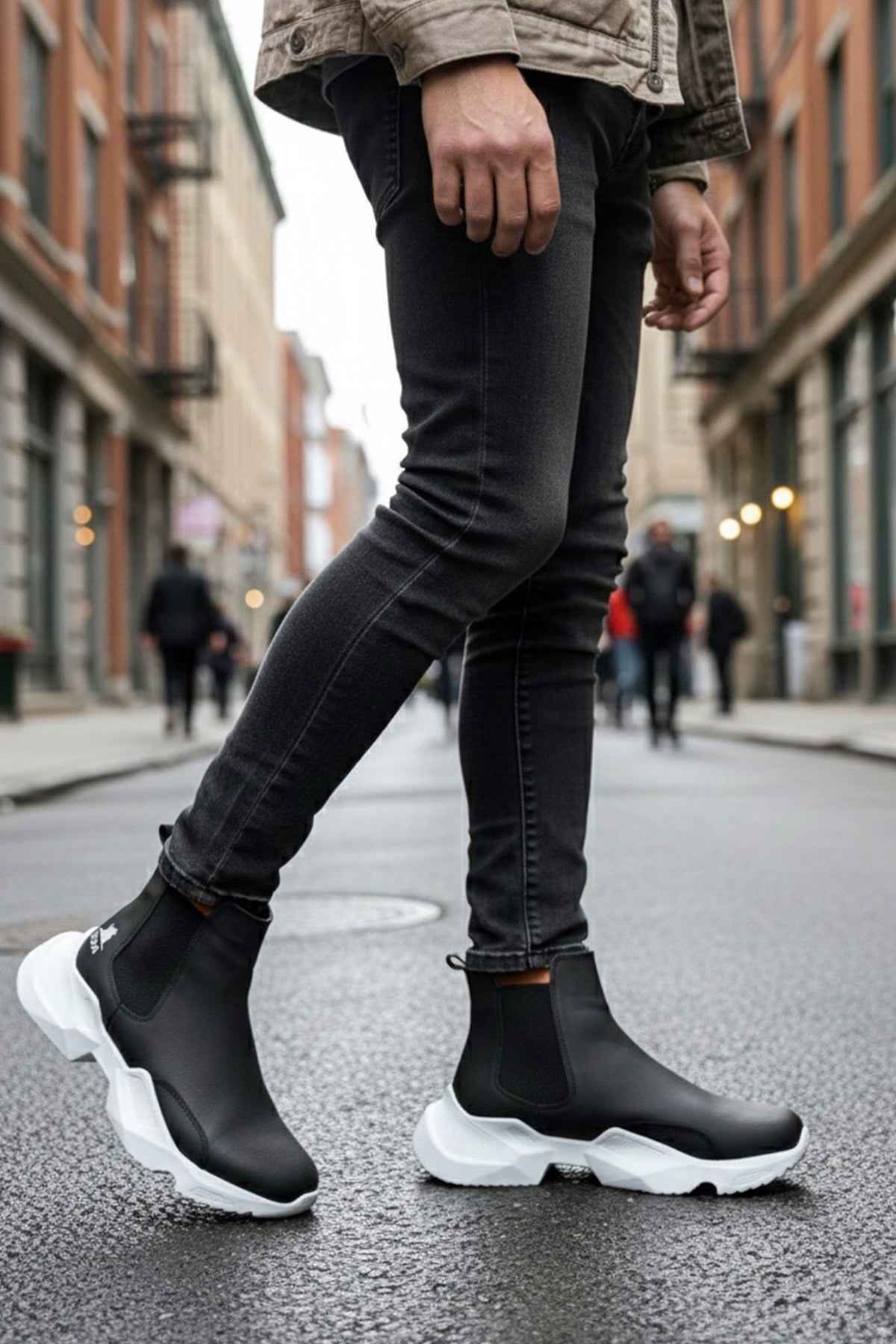 Men's black ankle boots with white chunky soles and elastic side panels
