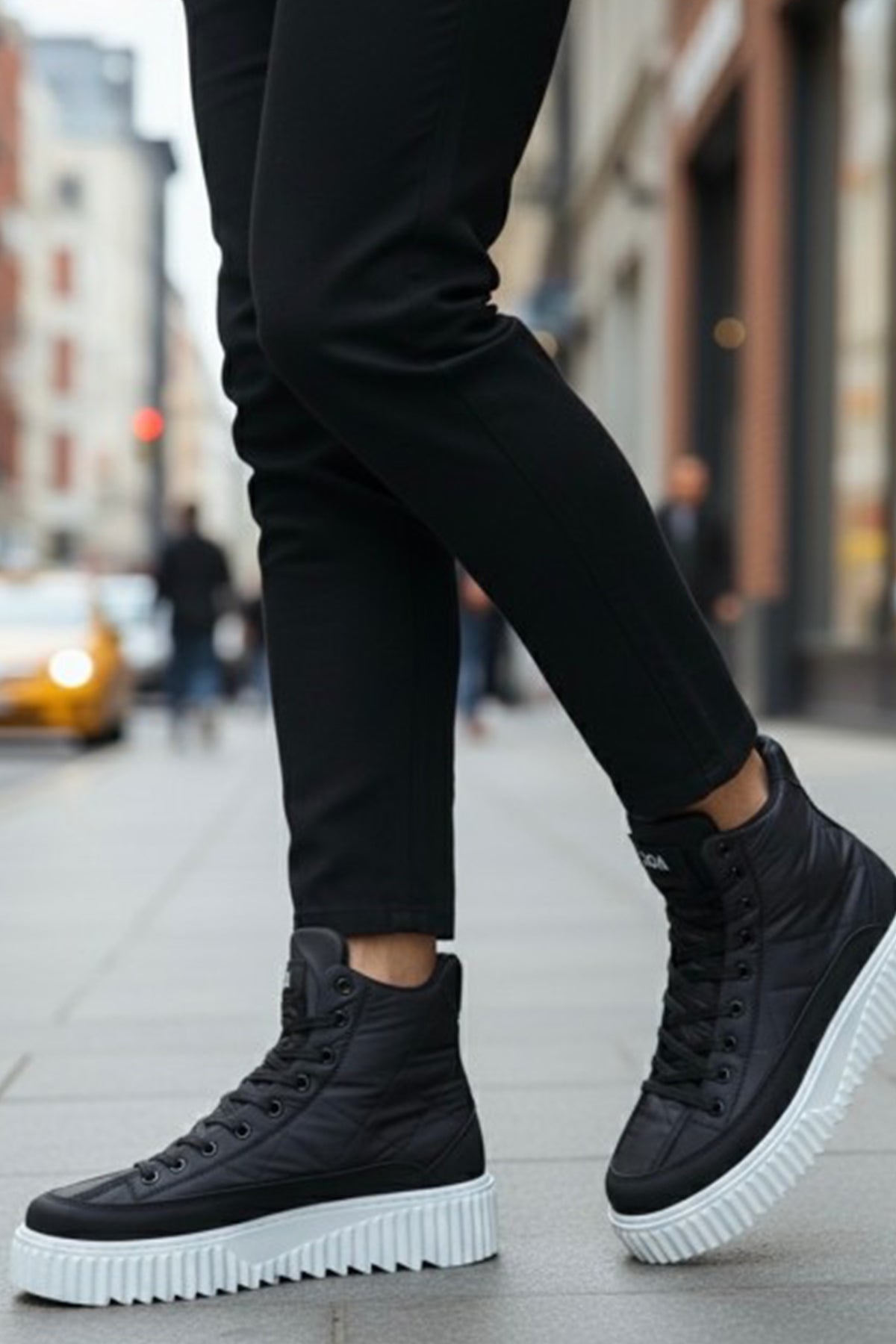 Men's black high-top boots with lace-up front and white platform sole