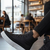 Men's black high-top lace-up boots with thick white sole