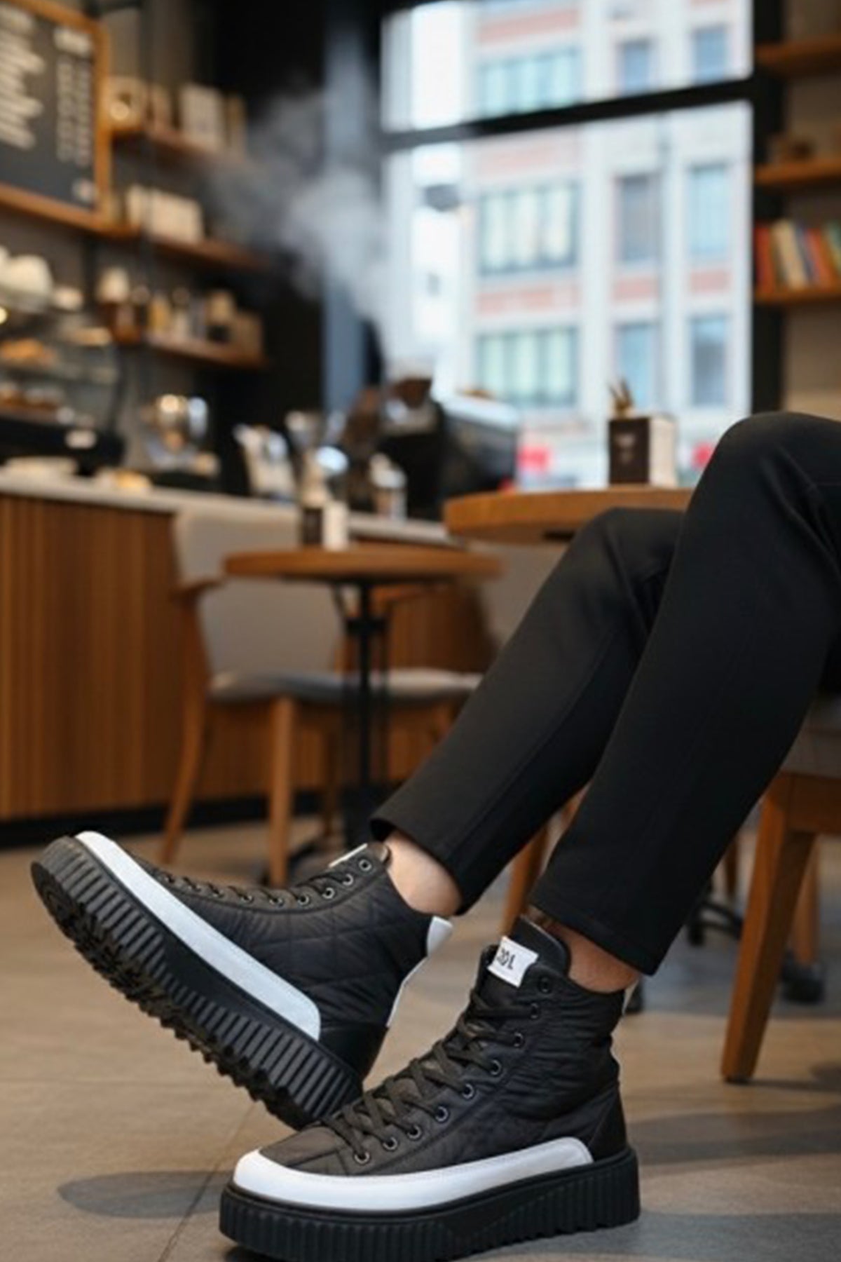 Black lace-up boots with white midsole and thick tread sole