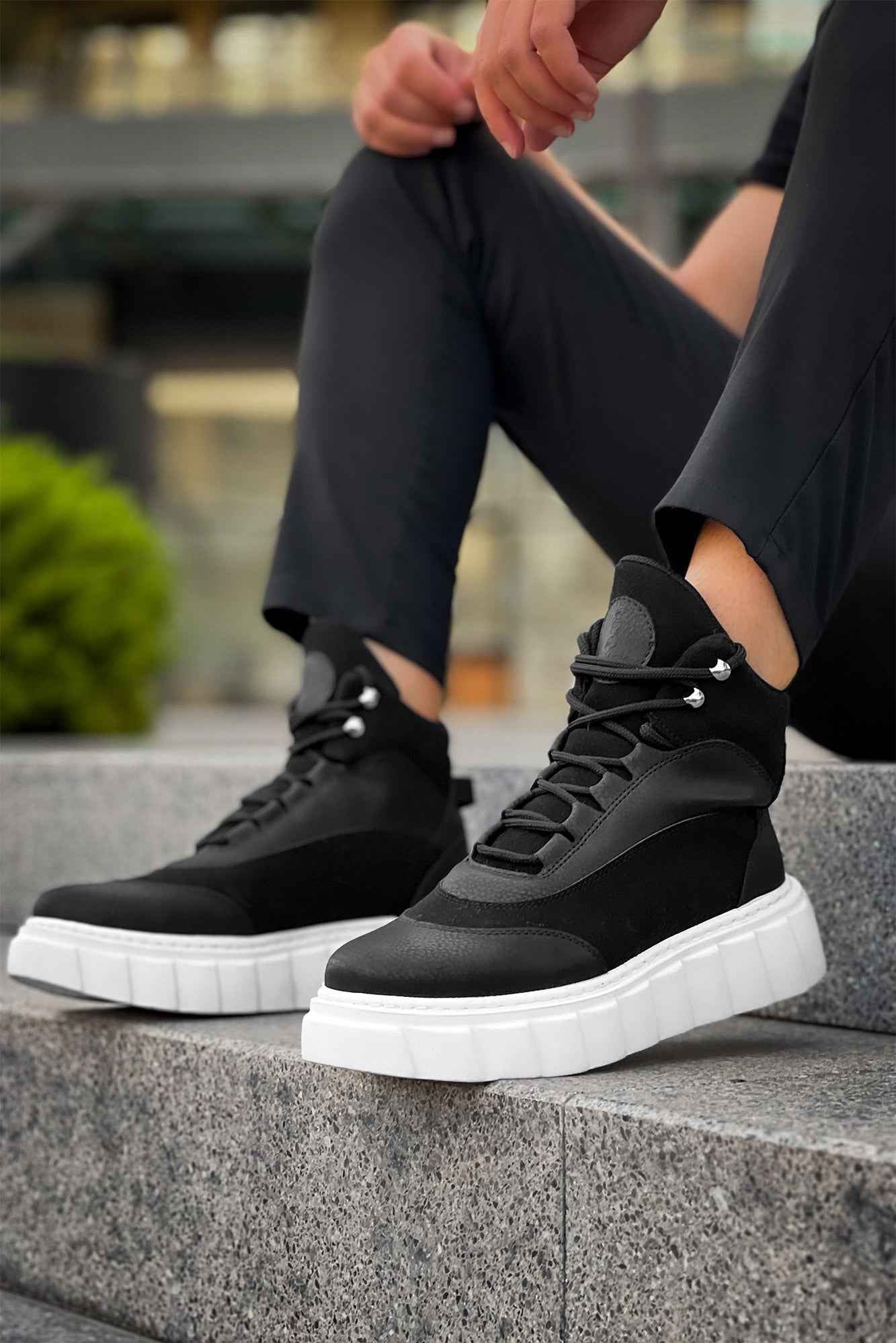 Men's black lace-up boots with white chunky sole and side panels