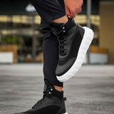 Men's black lace-up boots with white sole, raised ankle collar
