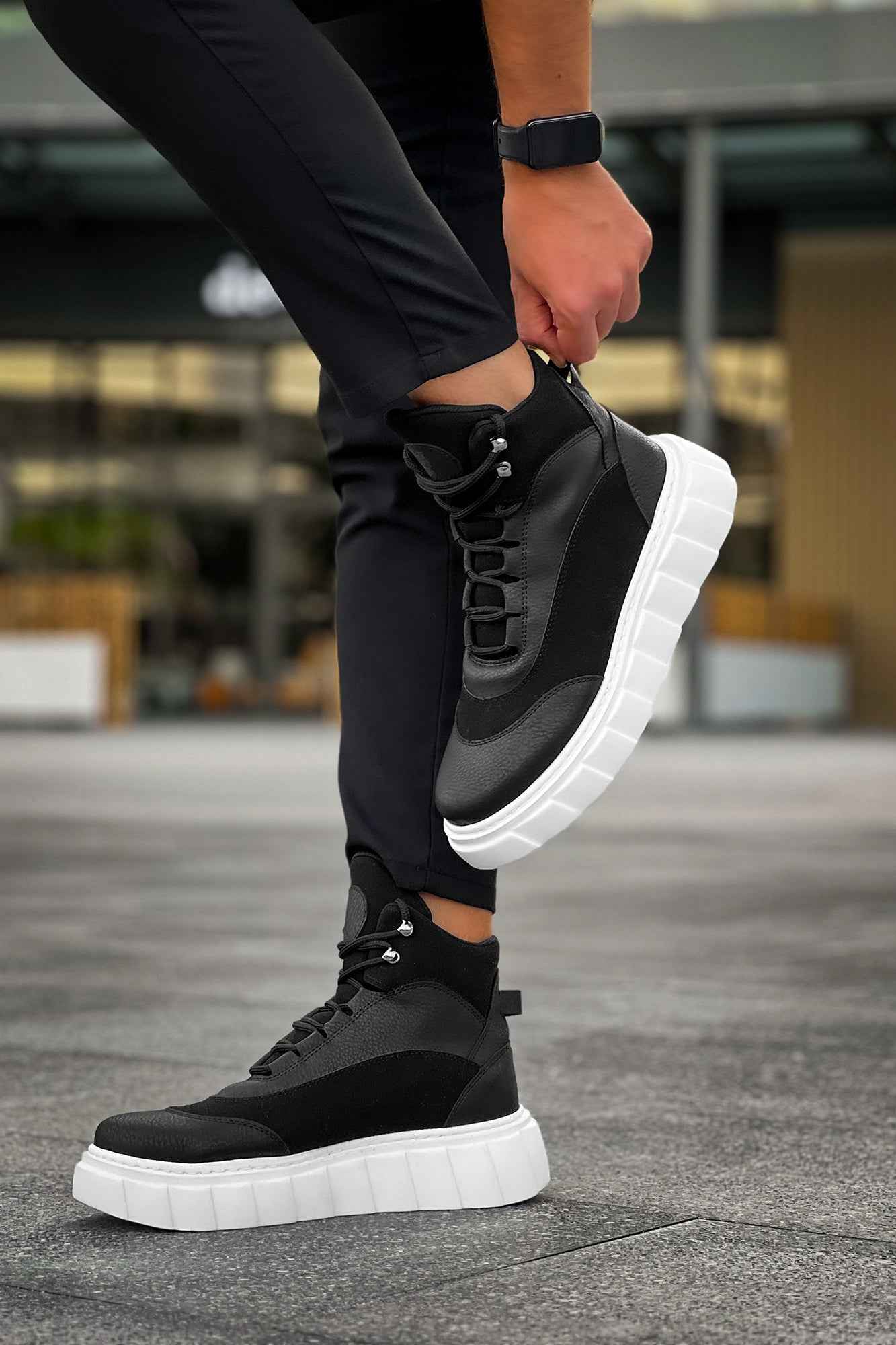 Men's black lace-up boots with white sole, raised ankle collar