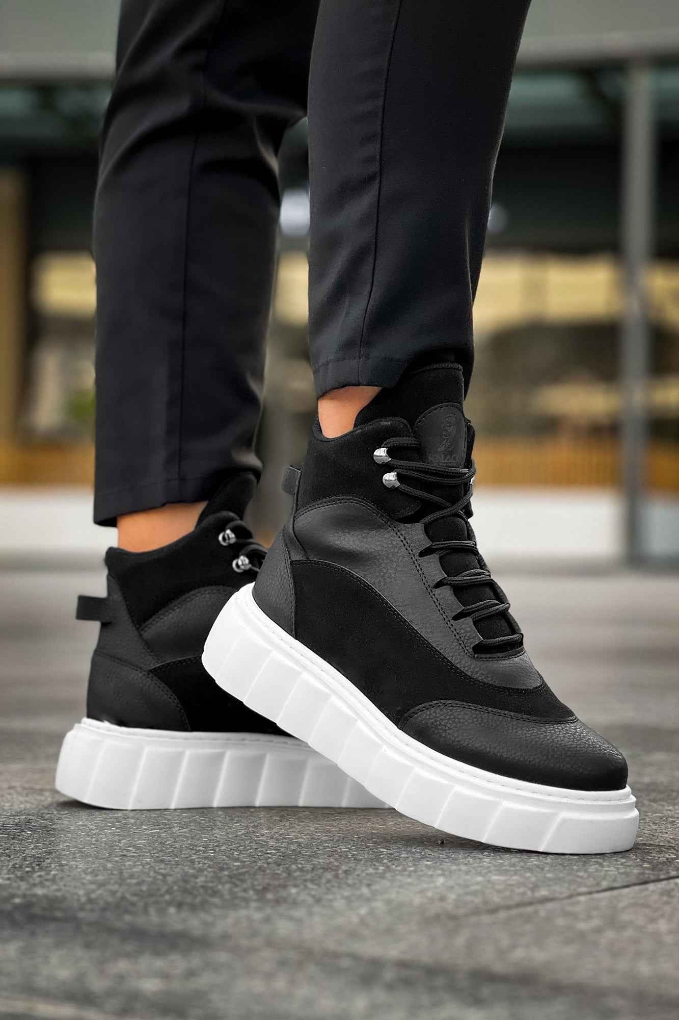 Men's black lace-up boots with white chunky sole and rounded toe