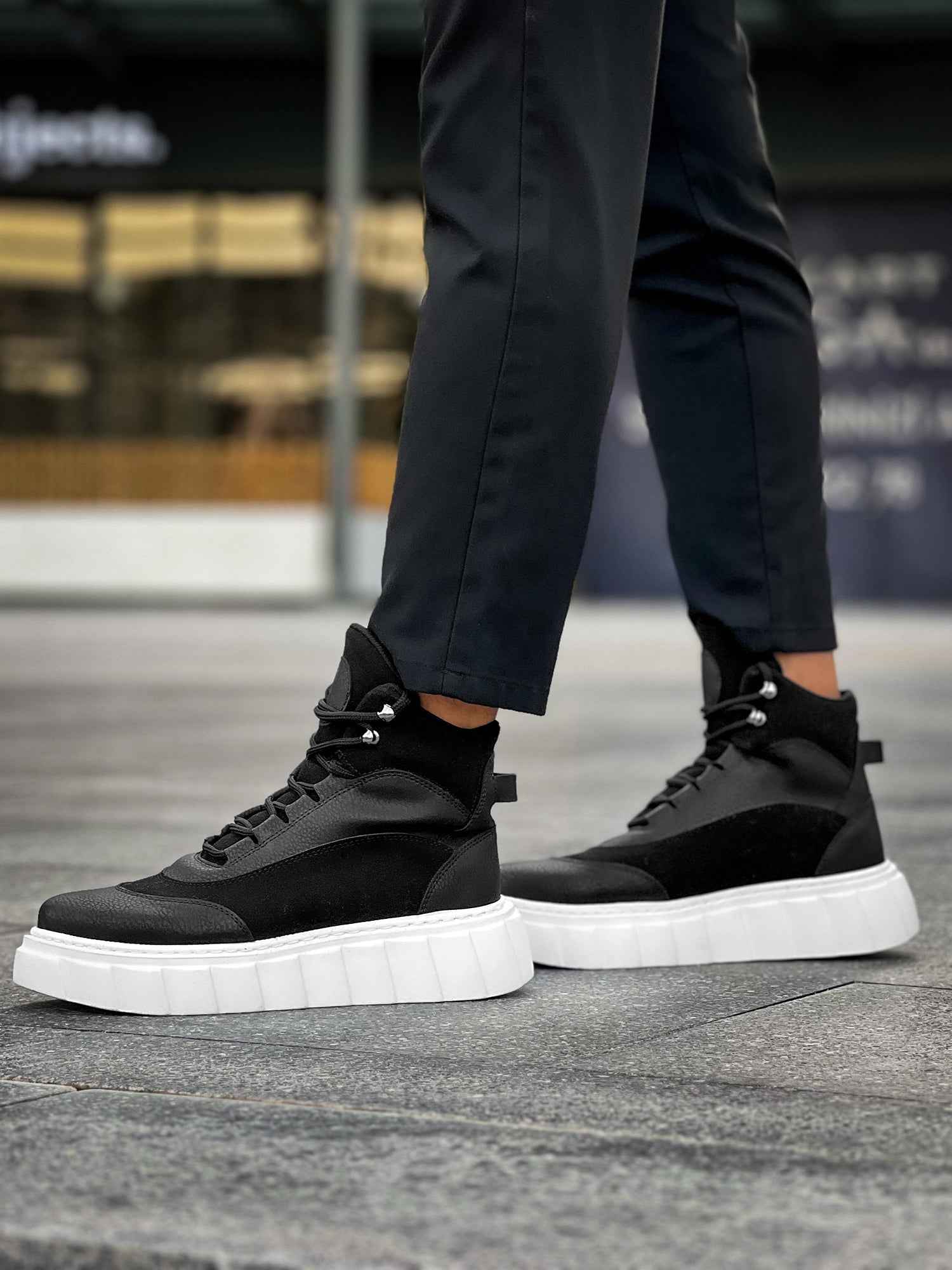 Men's black lace-up boots with white platform sole, front view