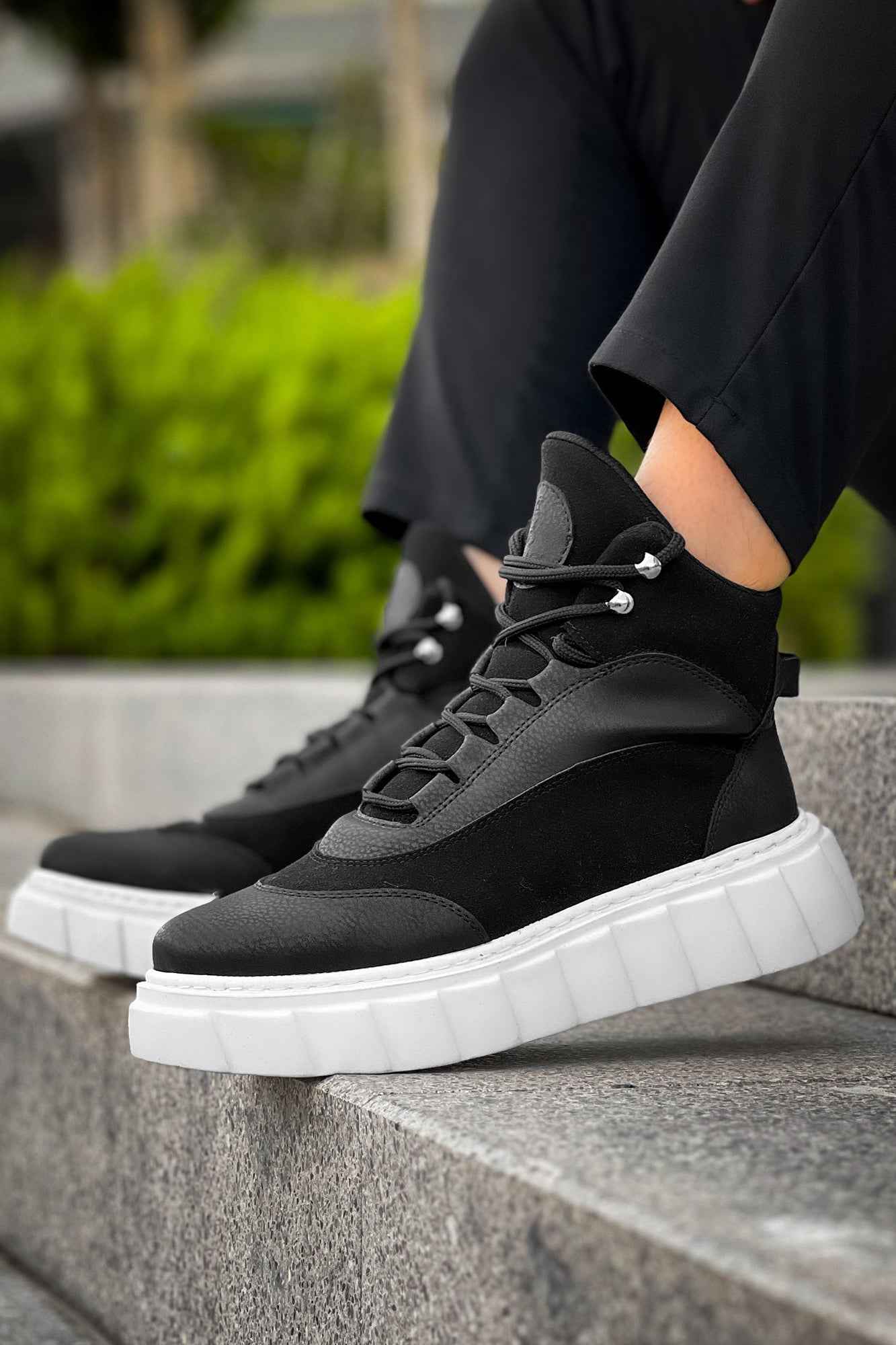 Men's black lace-up boots with white chunky sole and lace-up detail