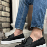 Black slip-on loafer with tassel detail and white cushioned sole