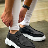 Men's black slip-on shoes with white chunky sole, side panel stitching