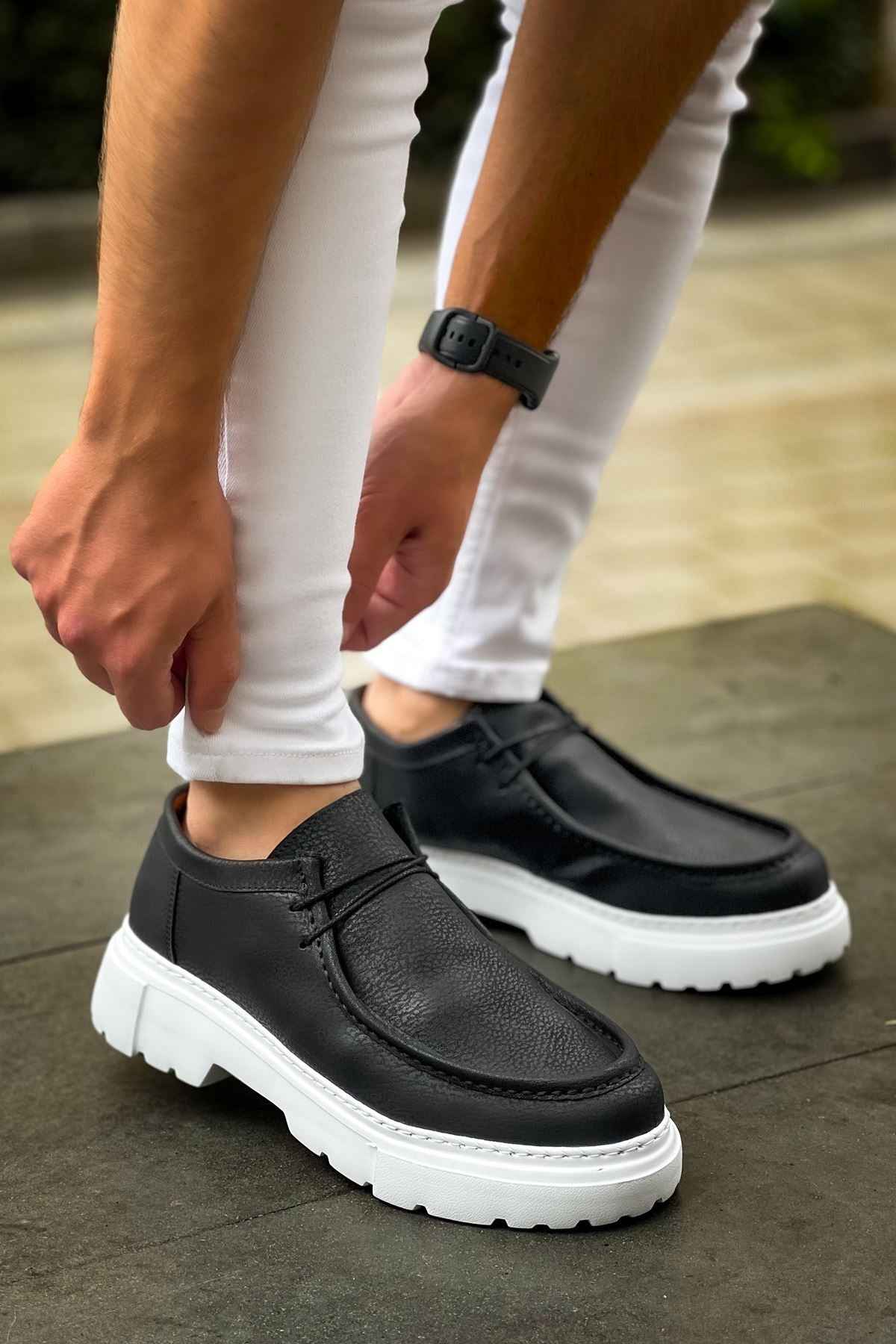 Men's black slip-on shoes with white chunky sole, side panel stitching
