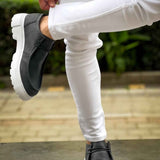Men's black slip-on shoes with white sole, side gore and pull tab