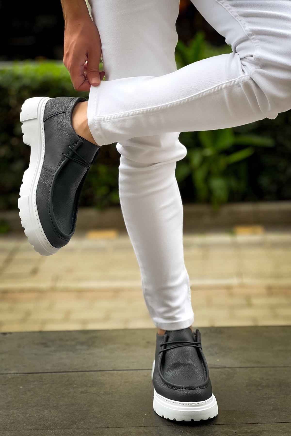 Men's black slip-on shoes with white sole, side gore and pull tab