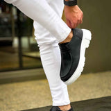 Men's black slip-on shoes with white sole, elastic gore and thick tread