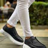 Men's black slip-on shoes with white chunky sole, front moc-toe design