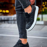 Men's black low-top sneakers, lace-up style with white sole and padded collar