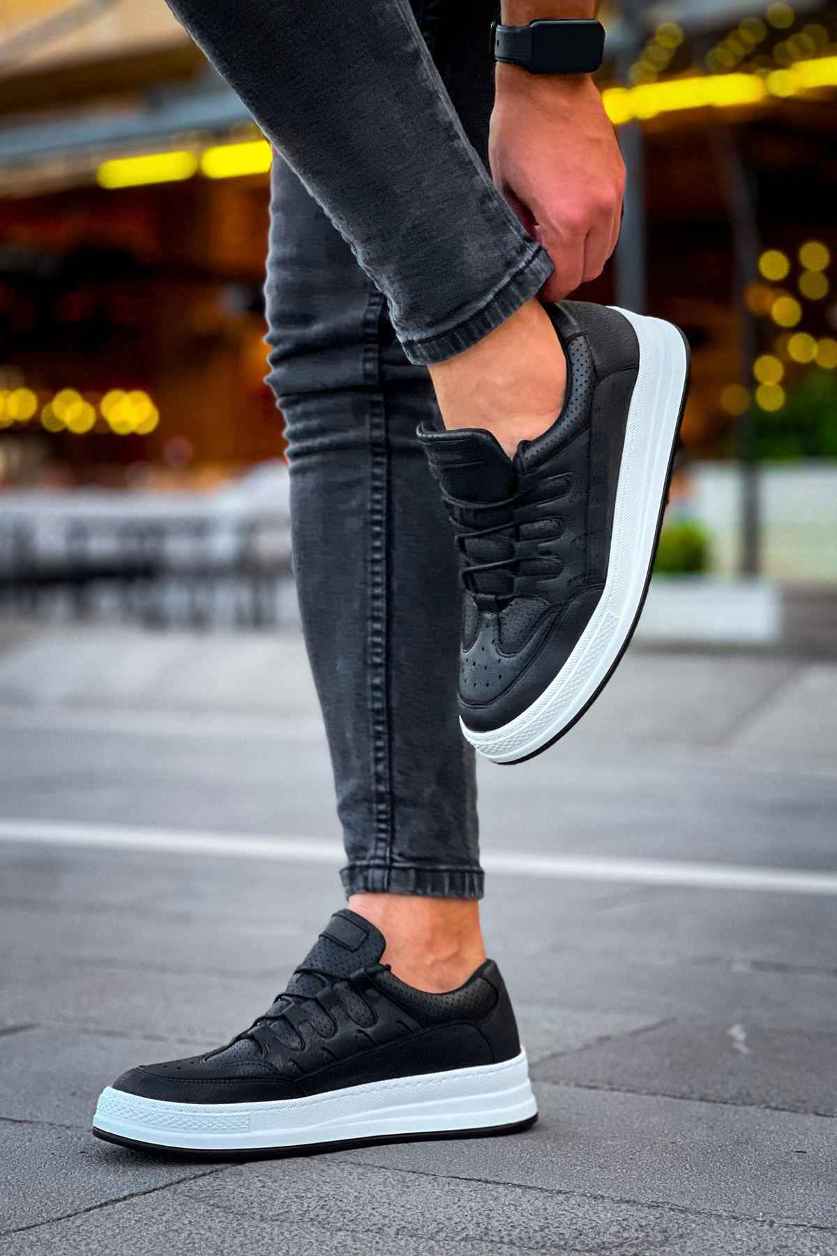 Men's black low-top sneakers, lace-up style with white sole and padded collar