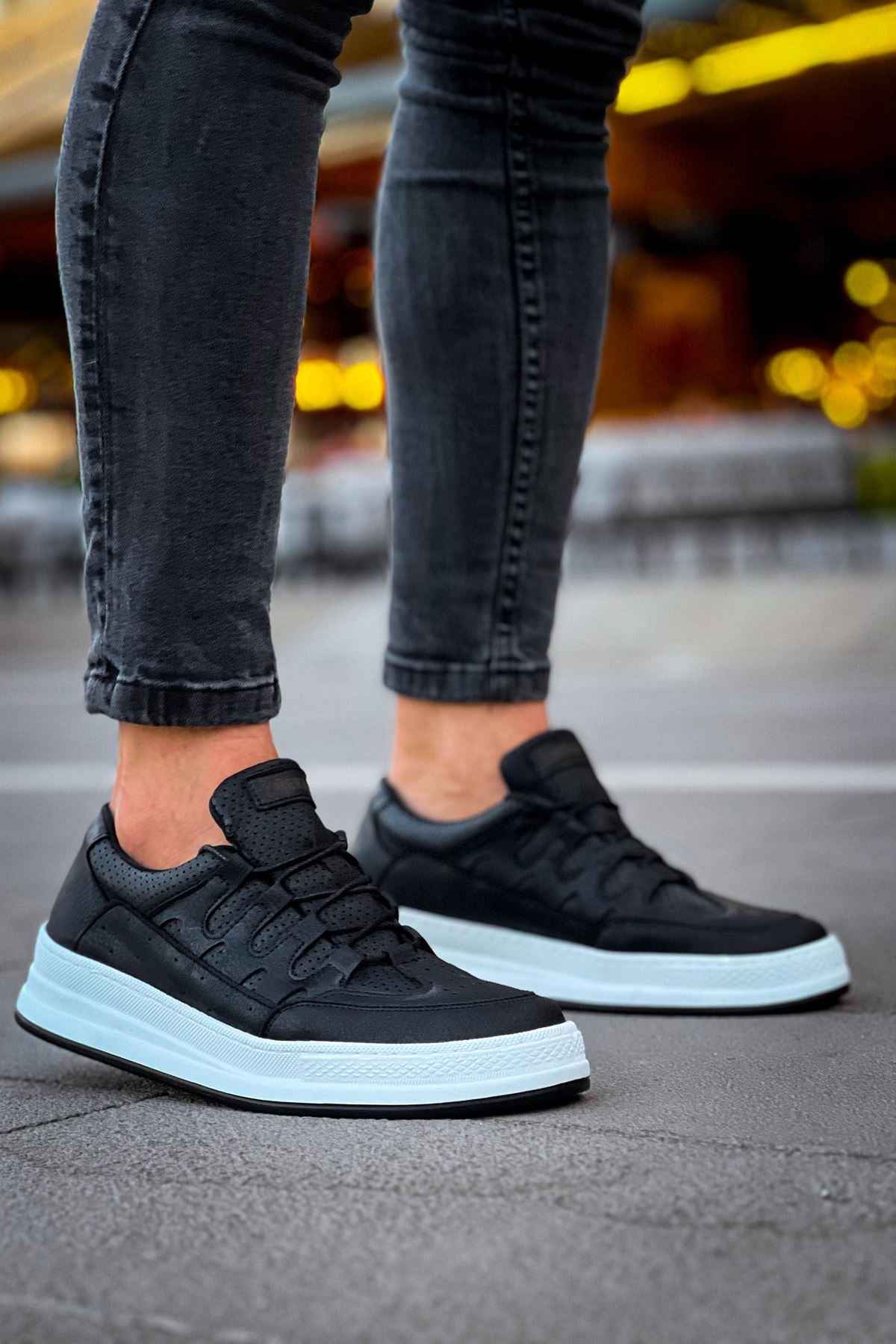 Men's black low-top sneakers with textured upper, lace-up front, white sole