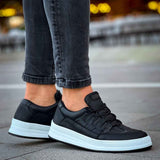 Men's black low-top sneakers with lace-up top and white sole, side view