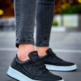 Men's black lace-up sneakers with white rubber sole and stitched panel detail