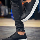 Black lace-up sneakers with white sole, front-and-side angle