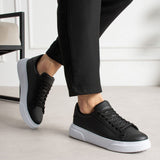 Black lace-up low-top sneakers worn with white midsole