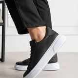 Black textured lace-up sneakers with thick white sole
