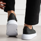 Black lace-up sneakers from heel view with white rubber sole