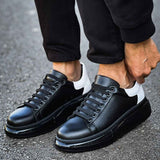 Black leather lace-up sneakers with white accent and black rubber sole