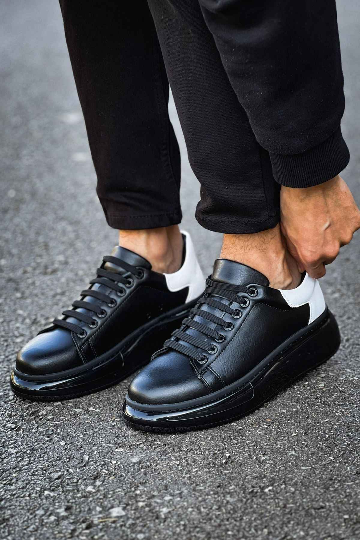 Black leather lace-up sneakers with white accent and black rubber sole