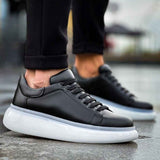 Men's black low-top sneakers with white rubber sole and stitched laces