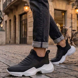 Men's black sneakers with white platform sole and cushioned slip-on upper