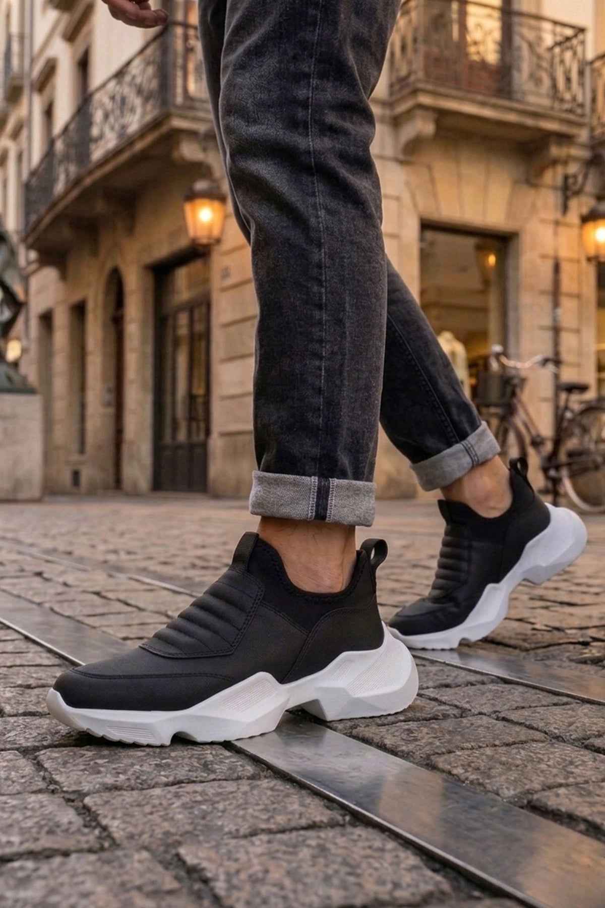 Men's black sneakers with white platform sole and cushioned slip-on upper