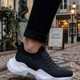 Men's black sneakers with white platform sole and elastic-like side panels