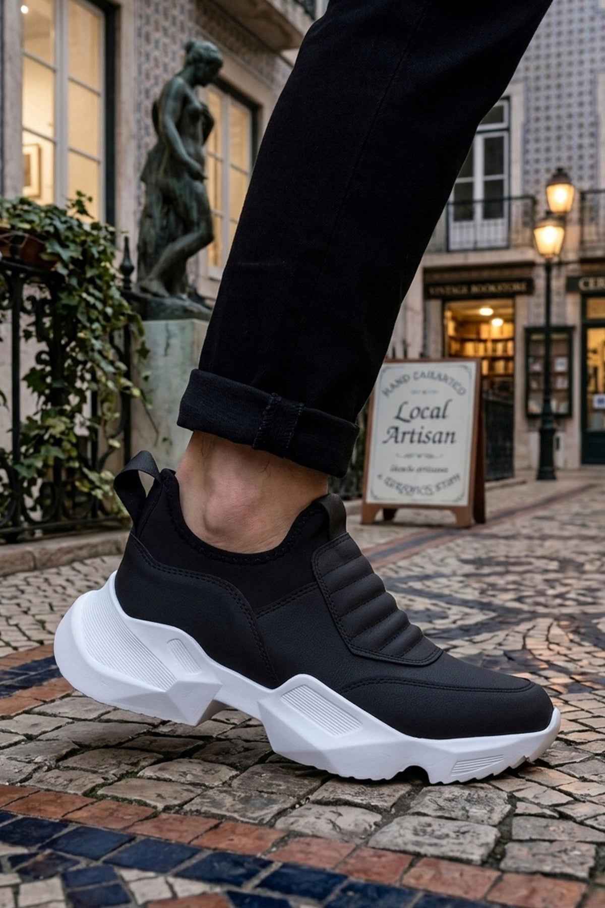 Men's black sneakers with white platform sole and elastic-like side panels