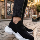 Men's black knit lace-up sneakers with white chunky sole, side view