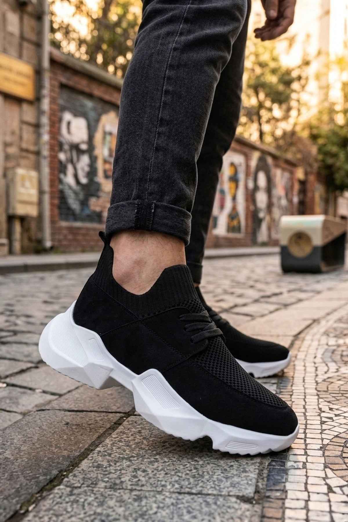 Men's black knit lace-up sneakers with white chunky sole, side view